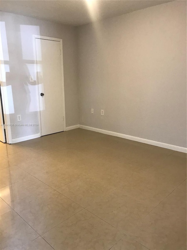 empty room with light tile patterned floors