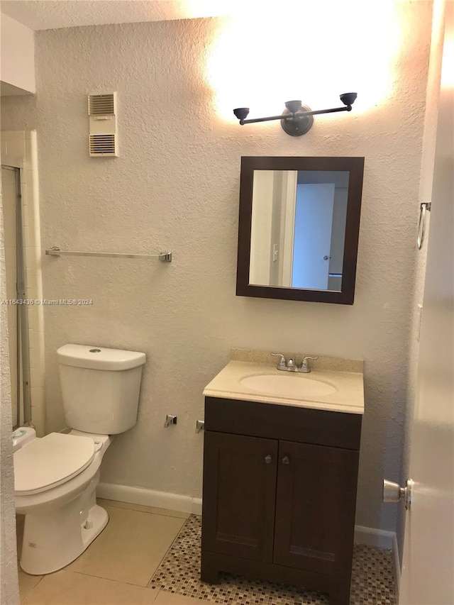 bathroom with tile patterned flooring, toilet, and vanity