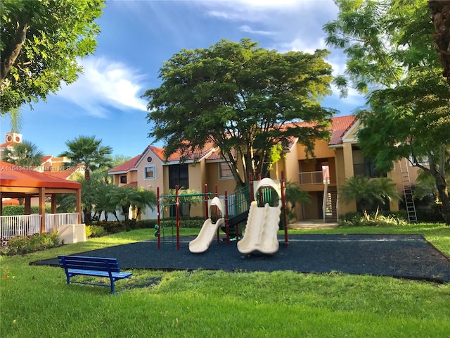 view of jungle gym featuring a lawn