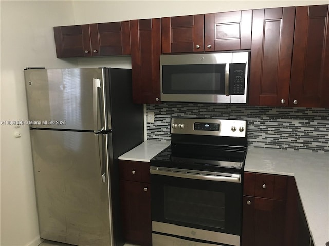 kitchen with appliances with stainless steel finishes and tasteful backsplash