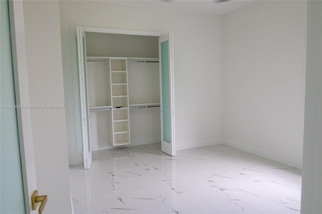 unfurnished bedroom with a closet and light tile patterned floors