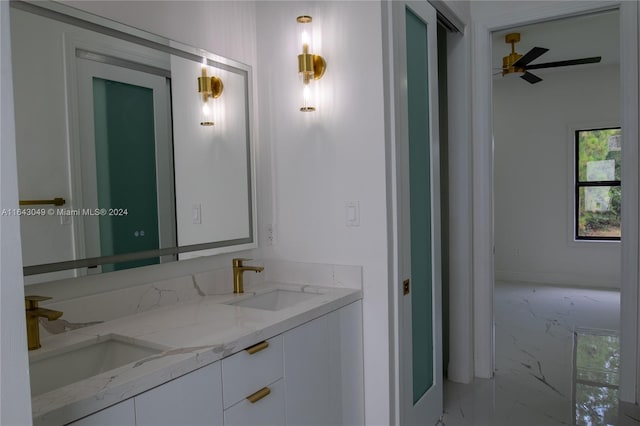 bathroom with ceiling fan and double vanity