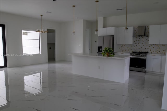 kitchen with backsplash, wall chimney exhaust hood, white cabinetry, light tile patterned floors, and stainless steel appliances