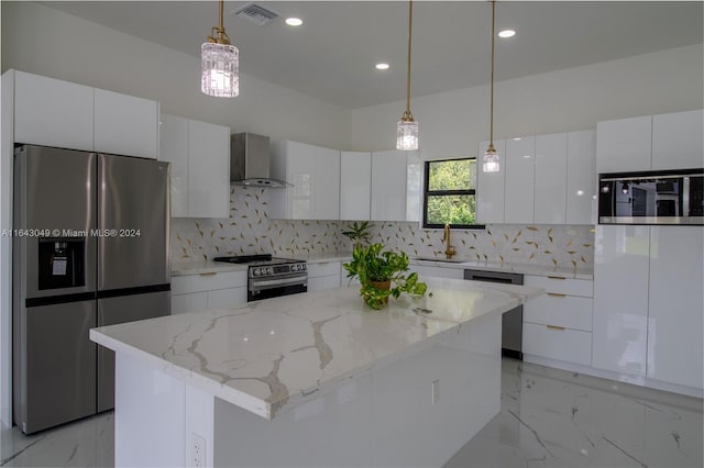 kitchen with appliances with stainless steel finishes, a kitchen island, wall chimney exhaust hood, and backsplash