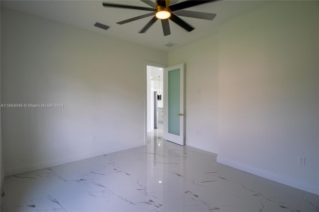 tiled empty room with ceiling fan