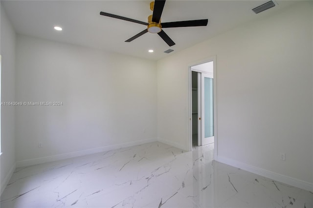 tiled empty room with ceiling fan