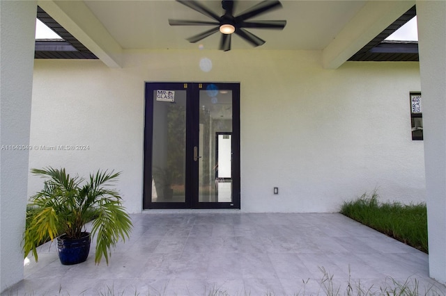 property entrance with ceiling fan, a patio, and french doors