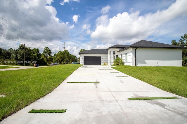 view of front of house featuring a garage and a front lawn