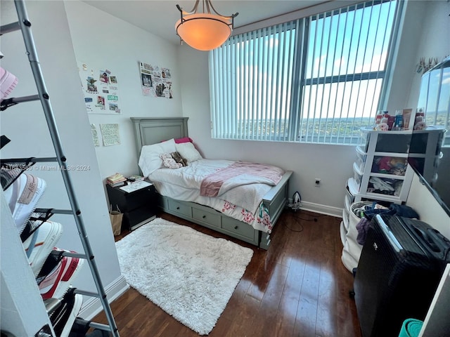 bedroom with dark wood-type flooring