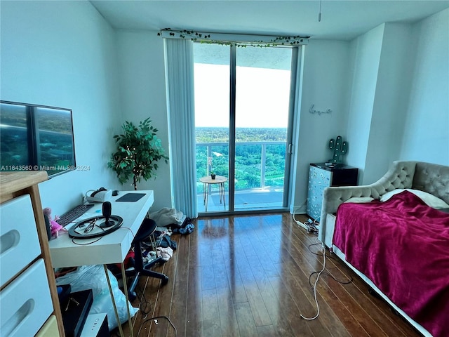 bedroom with access to outside and hardwood / wood-style floors