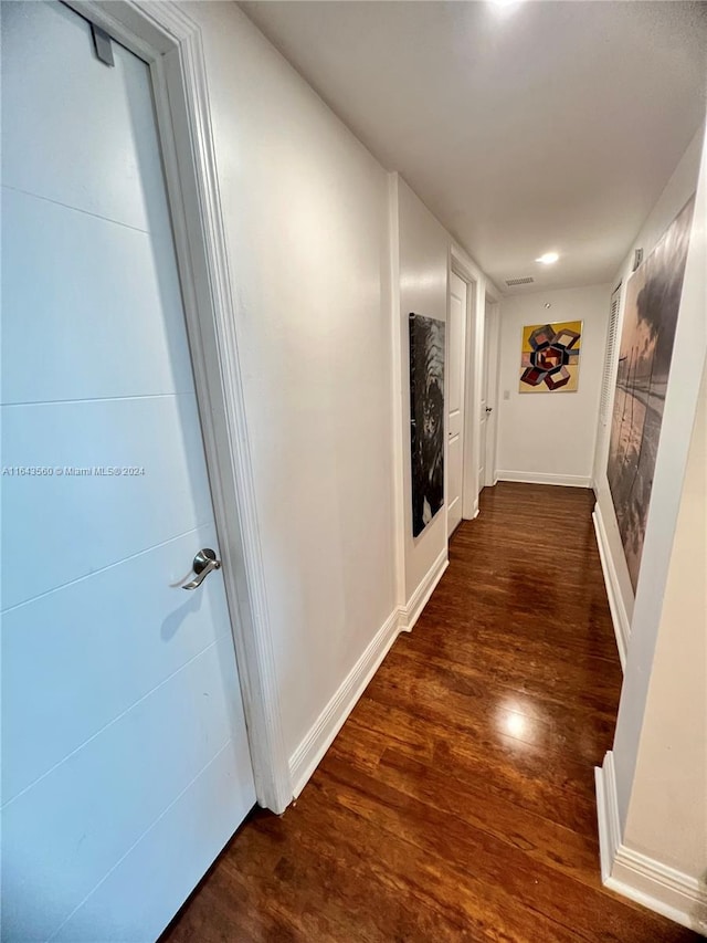 corridor featuring dark hardwood / wood-style flooring