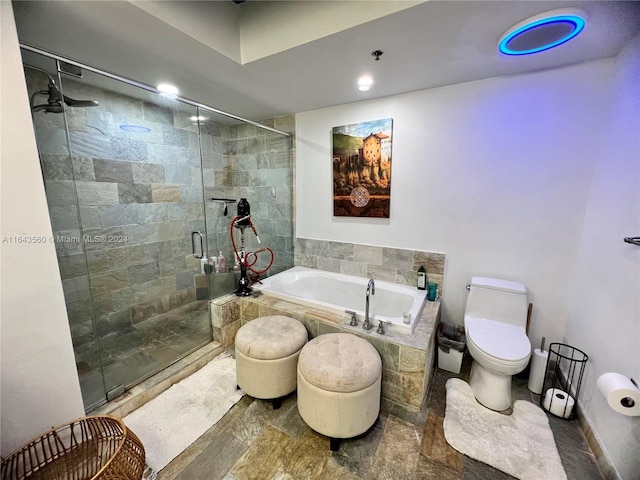 bathroom featuring shower with separate bathtub, toilet, and hardwood / wood-style flooring