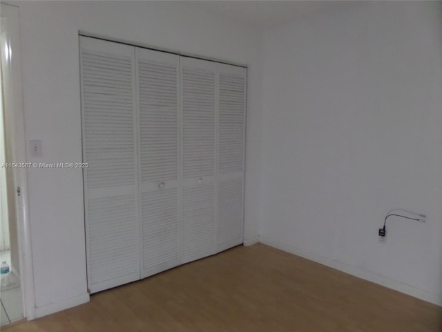 17530 NW 68th Ave Unit C4002, Hialeah, FL 33015 - unfurnished bedroom with wood finished floors, baseboards, and a closet