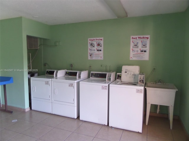 17530 NW 68th Ave Unit C4002, Hialeah, FL 33015 - shared laundry with washing machine and clothes dryer, light tile patterned flooring, and baseboards