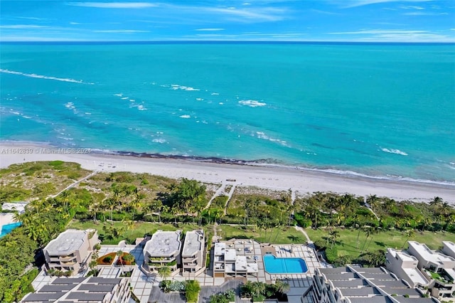 drone / aerial view featuring a water view and a beach view