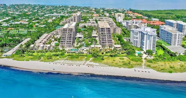 birds eye view of property featuring a beach view and a water view