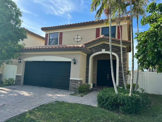 mediterranean / spanish-style house featuring a garage