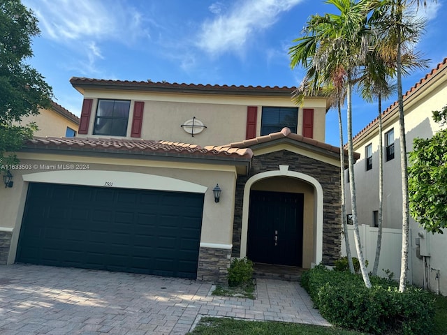 mediterranean / spanish house featuring a garage