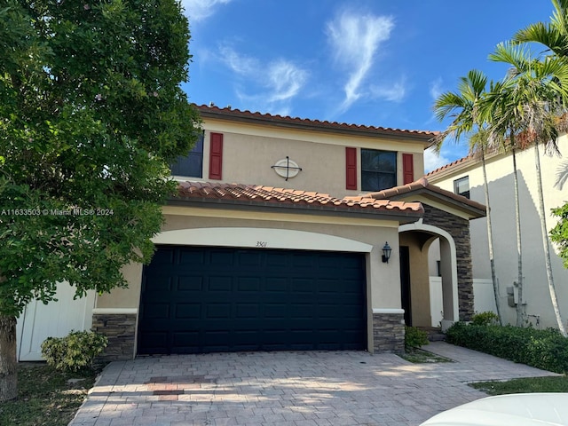 mediterranean / spanish house featuring a garage