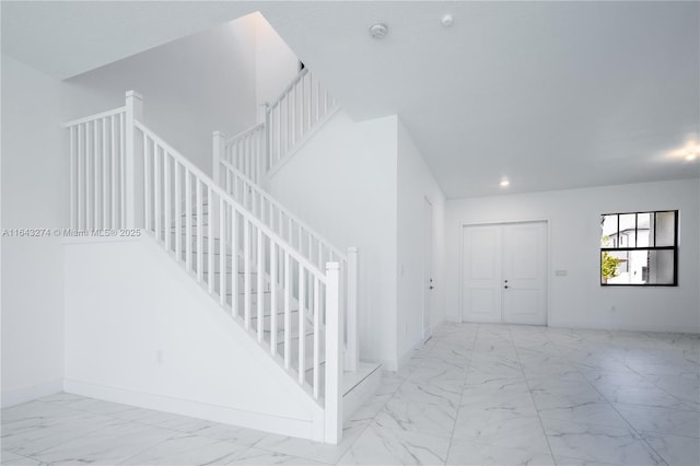 stairs featuring recessed lighting, marble finish floor, and baseboards