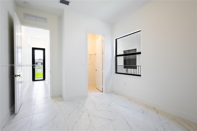 unfurnished room featuring marble finish floor, baseboards, and visible vents