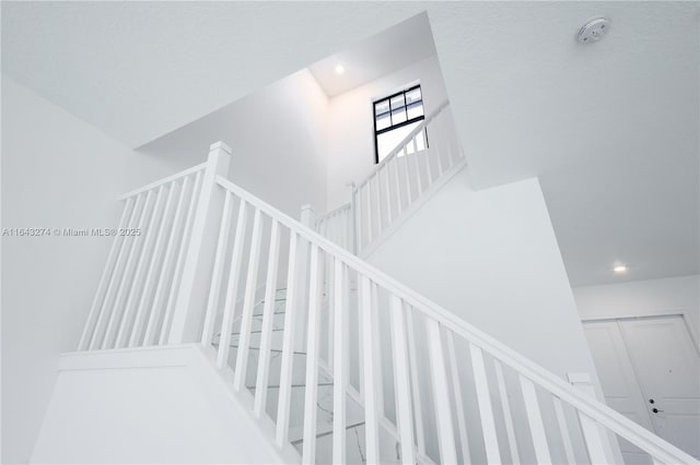 stairway featuring recessed lighting