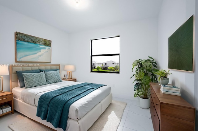 bedroom with marble finish floor and baseboards