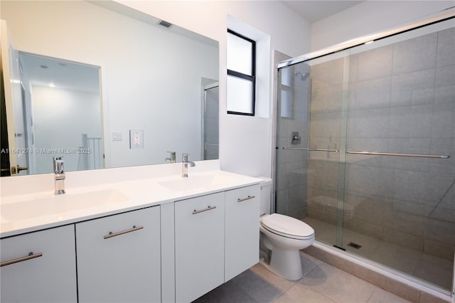 bathroom featuring a stall shower, a sink, and double vanity