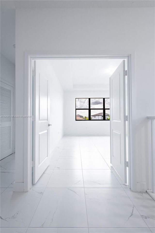 hallway with marble finish floor