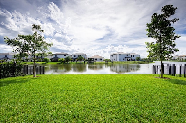 view of water feature featuring fence and a residential view