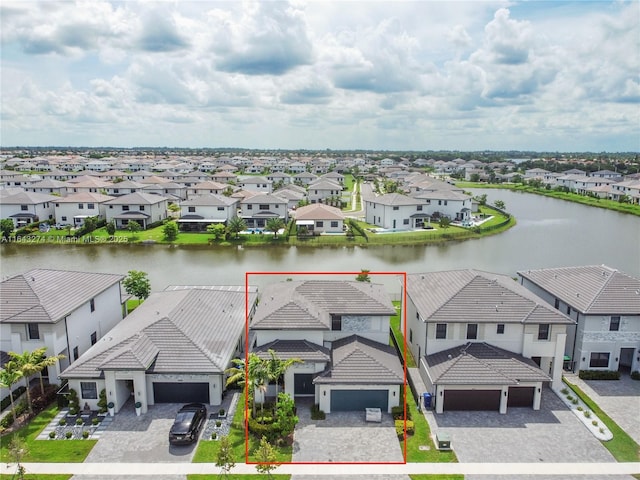 drone / aerial view with a water view and a residential view