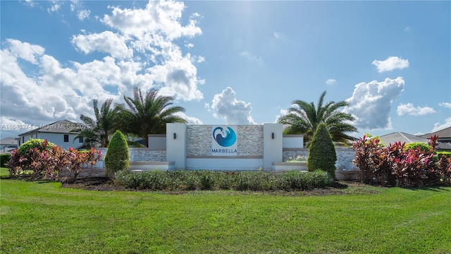 community sign featuring a lawn