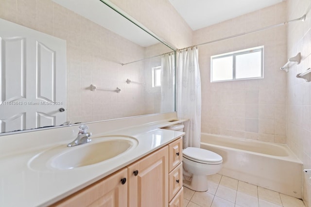 full bathroom featuring tile patterned floors, vanity, shower / tub combo, and toilet