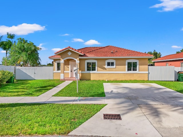 mediterranean / spanish house with a front yard