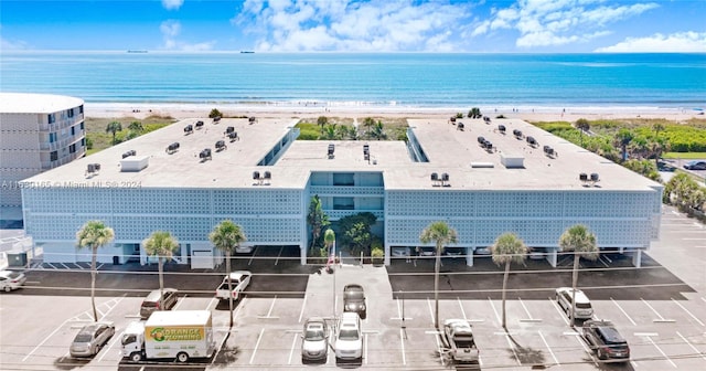 birds eye view of property with a beach view and a water view