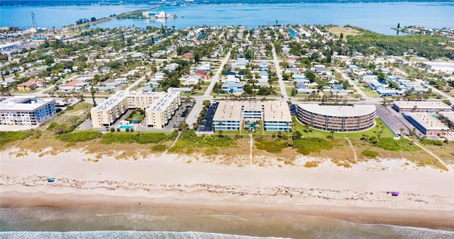 birds eye view of property with a water view and a view of the beach