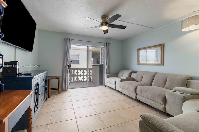 tiled living room with ceiling fan and a textured ceiling