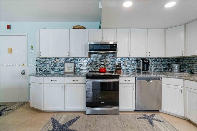 kitchen featuring white cabinetry, stainless steel appliances, and tasteful backsplash