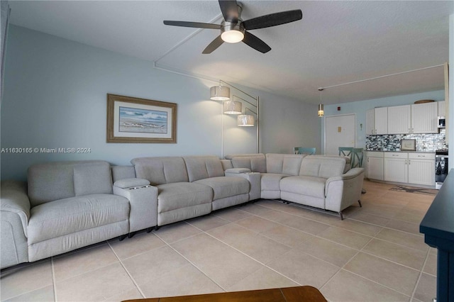 living room with ceiling fan and light tile patterned floors