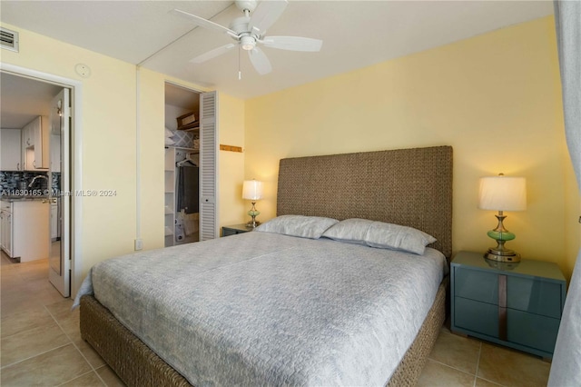 bedroom with light tile patterned floors, ceiling fan, visible vents, and a closet