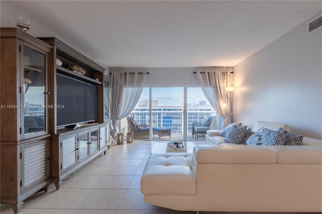 living room featuring light tile patterned flooring and a textured ceiling