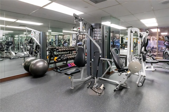 exercise room with a paneled ceiling