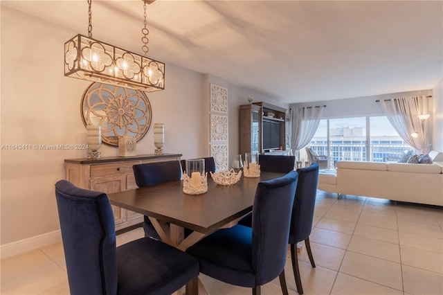 tiled dining area with a notable chandelier