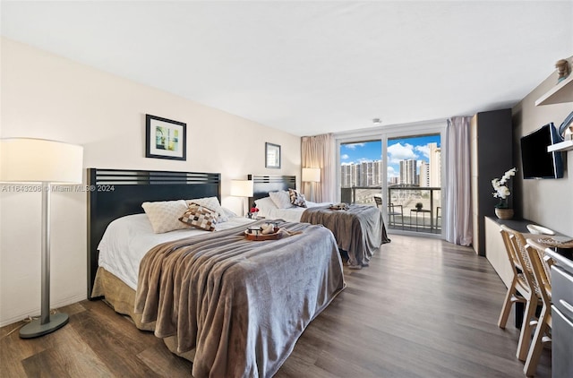 bedroom with dark wood-type flooring and access to outside