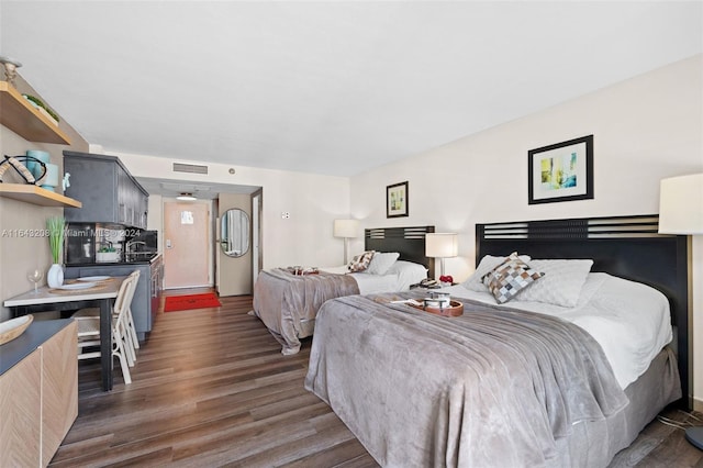 bedroom with dark wood-type flooring