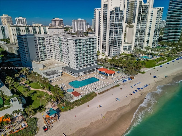 birds eye view of property with a beach view and a water view