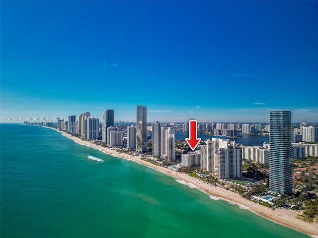 bird's eye view featuring a water view and a view of the beach