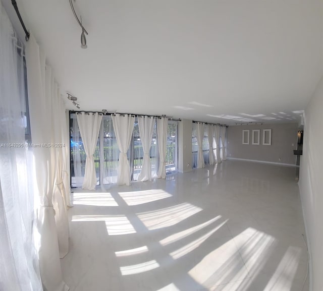 spare room featuring light tile patterned flooring