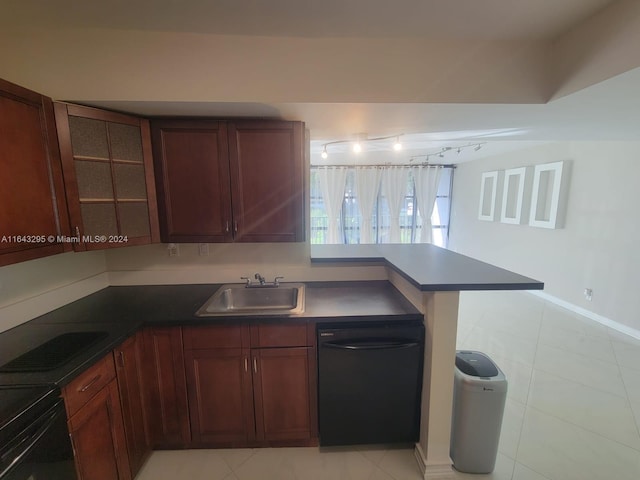 kitchen featuring kitchen peninsula, black dishwasher, track lighting, sink, and light tile patterned floors