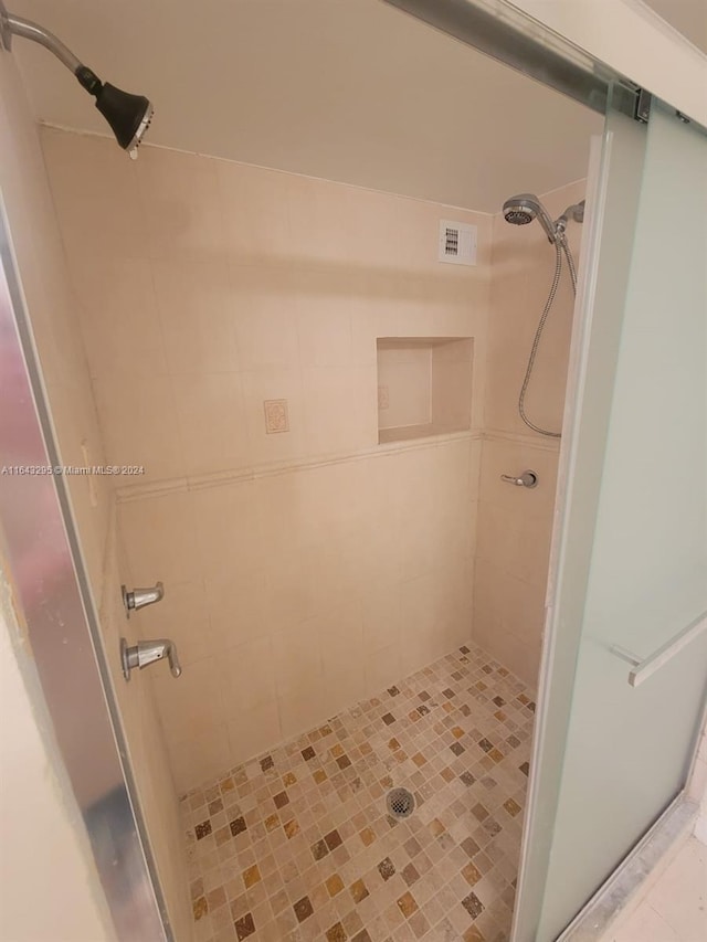 bathroom with tiled shower